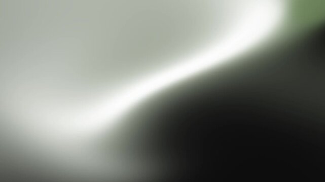 Abstract soft focus background with diffused bright light glowing through dark moody textures and subtle green tones