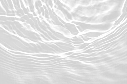 Black and white abstract water ripple texture with light caustics