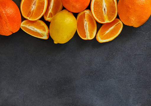 Healthy food background. Healthy eating concept, fresh citrus fruits. On a black wooden background. Side view. Selective focus
