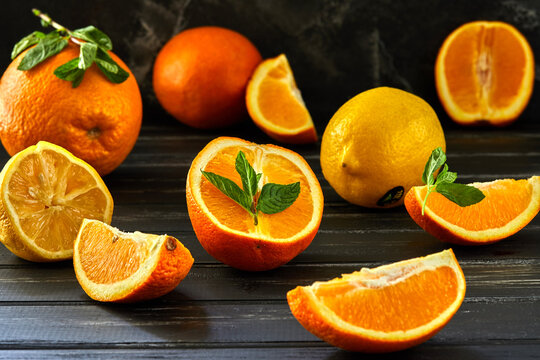 Healthy food background. Healthy eating concept, fresh citrus fruits. On a black wooden background. Side view. Selective focus