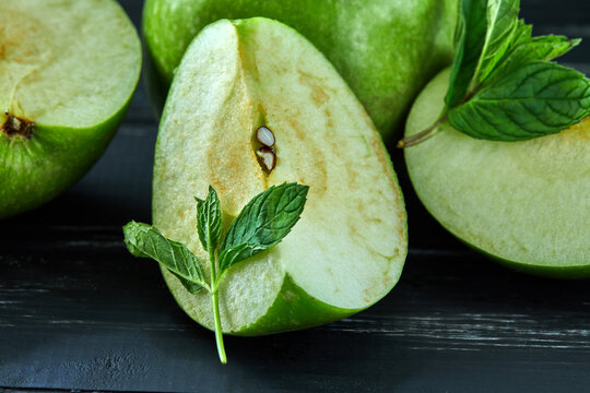 Healthy food background. The concept of healthy eating, fresh apples. On a black wooden background. Side view. Selective focus