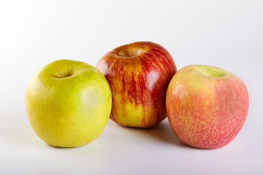 Red apple, green and pink apples isolated on white background