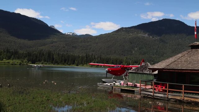 Seaplane by the cabin on a lake in Canada, wild mountain landscape