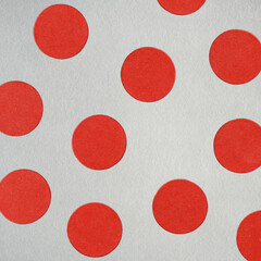 Red circular polka dots creating a geometric pattern on gray textured paper. Grunge, noise and motion blur effect applied © Rytis
