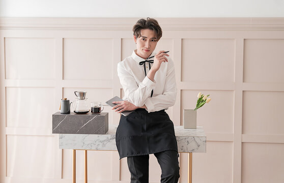 Startup successful small business owner man sme, handsome men sit in coffee shop restaurant. Portrait of young relax asian man barista cafe local owner. SME sell online entrepreneur business banner