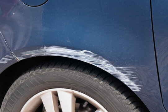 Paint Scratches on Car Fender After a Parking Mishap &ndash; Vehicle Damage and Auto Insurance Concept