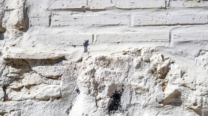 Fototapeta premium Textura de pared blanca de ladrillo y piedra rugosa