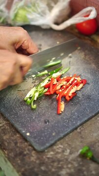 Cooking Thai fried tilapia with spicy red curry sauce. Deep-frying whole tilapia until golden crispy, sauteing red curry paste with palm sugar, sliced chilies, and kaffir lime leaves, pouring over fis