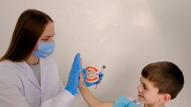 A child at the dentist gets his teeth treated. Selective focus.
