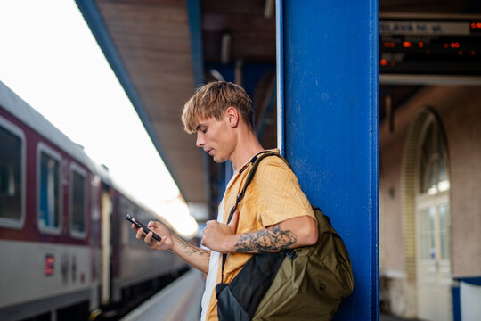 University student buying train ticket online before departure.