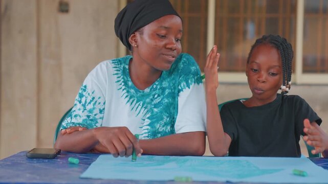 Gentle mother guides young learner. Responsible mother carefully instructs her small inquisitive child. Nurturing mother softly mentors and educates her inquisitive young child with patience