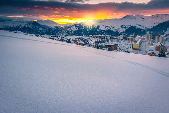 Ski tracks in the deep snow at sunrise, France
