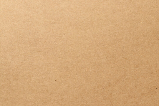 Brown cardboard sheet abstract background, texture of sepia color kraft paper with vintage pattern for design art work.