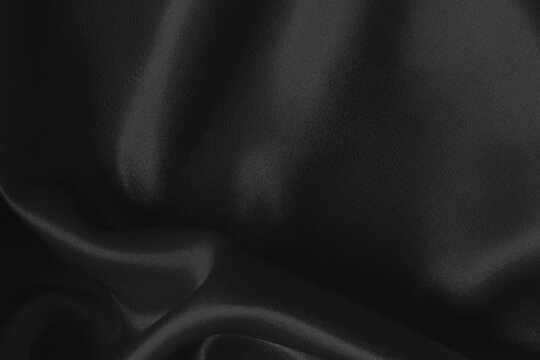 Black fabric cloth texture for background and design art work, beautiful crumpled pattern of silk or linen.