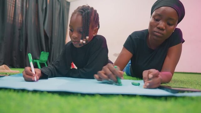 Creative family bonding. Loving mother and child express creativity with bright markers on floor. Warm family moment as mother and child engage in playful artistic activity with vibrant colors