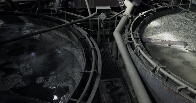Flotation and processing for copper production from ore. Closeup of fine pulp with bubbles, concentration industry plant.