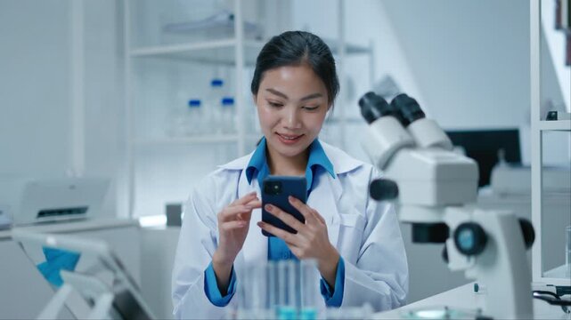 Asian Researcher using a microscope in the clinical lab.Female Researcher working in the clinical laboratory,Medical or scientific researcher or Asian woman doctor looking at professional microscope.
