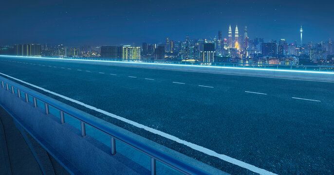 3d rendering empty highway leading to kuala lumpur city skyline at night