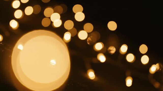 Golden bokeh string lights on dark background