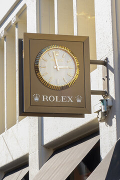 den haag, netherlands - march 18 2026: People walk by as a clock shows the time outside a Rolex store during daylight in a busy urban area