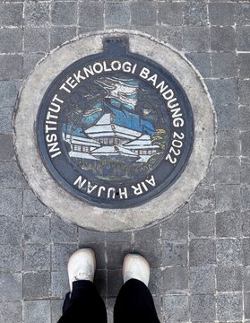 Bandung, Indonesia - July 22, 2026: Manhole cover with the design of Institut Teknologi Bandung building on it.