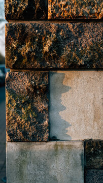 Close-up of stacked bricks with weathered textures and colors.