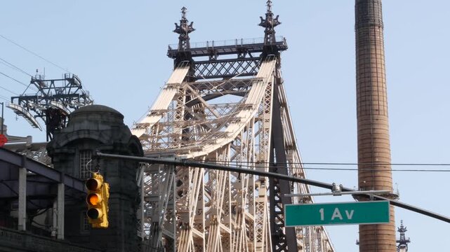 New York City Manhattan Midtown, Queensboro bridge architecture in United States. Urban transport bridge over East River. Yellow traffic light under metallic bridge in East Side. First 1st avenue sign