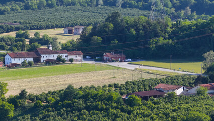 Obraz premium Aerial View of Traditional Farmhouse and Agricultural Fields in Piedmont Italy