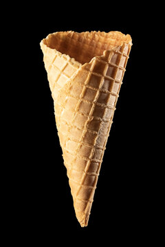 Empty waffle ice cream cone isolated on black background, vertical