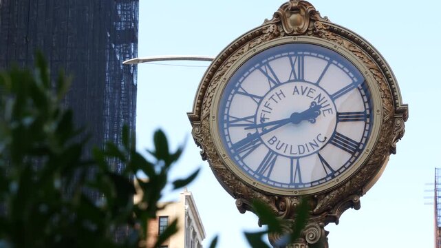 New York City Manhattan Midtown, United States of America. Street Clock on Broadway in Flatiron district near Madison Square Park. 5 fifth avenue Nomad area. Iconic golden clock, vintage clock face.