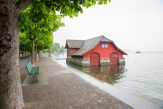 lakeside promenade Luzern with chestnut trees, historic red boathouse. switzerland