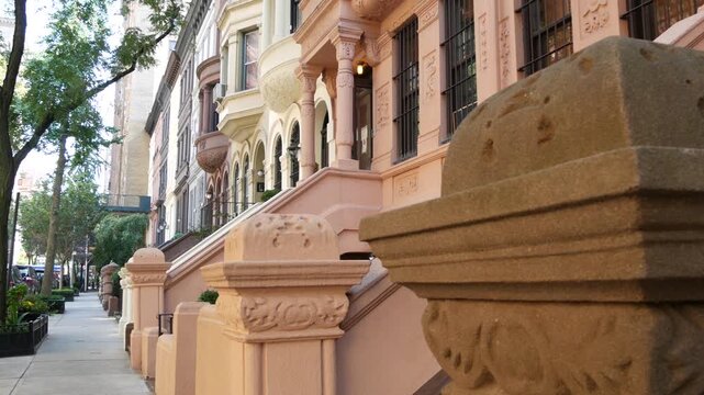 New York City townhouse buildings, brownstone row houses in Manhattan or Brooklyn, United States of America. Classic buildings on residential district street. Real estate property. Rowhouse townhome.