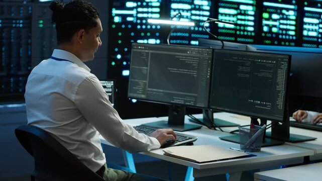 System administrator provides technical support in a technical server room, connecting network security, data protection and database reliability during digital infrastructure maintenance