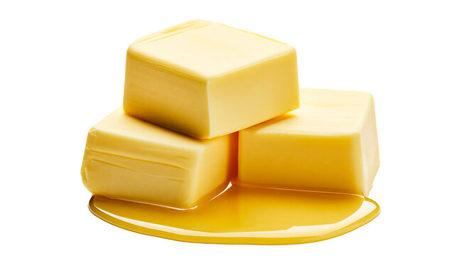 Three butter cubes melting in golden liquid