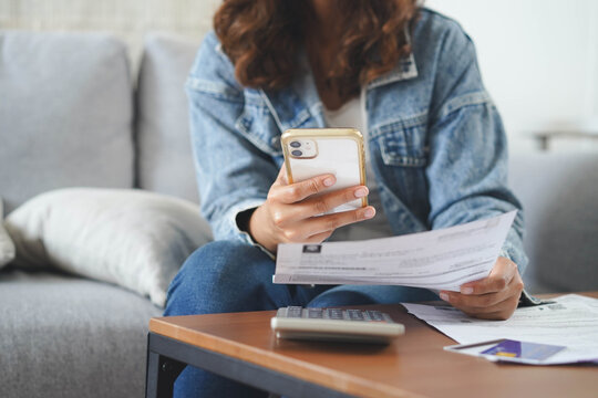 person pay bills via mobile banking at home