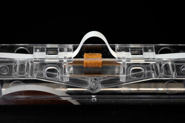 Naklejka premium Magnetic tape head opening and pressure pad close up of audio cassette