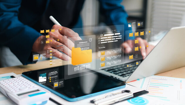 Business professional using digital file management tools on laptop and tablet, featuring organized folders, documents, workflow data, and modern technology for efficient office productivity.