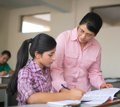 Teacher assisting student in classroom