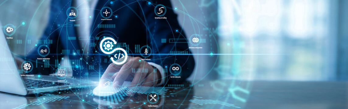 Engineer working on laptop using DevOps network pipelines to integrate code deployments. Coordinating between development and operations teams to ship software updates faster and more reliably.