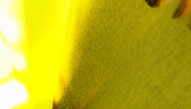 Close-up view of yellow spray paint particles creating a textured