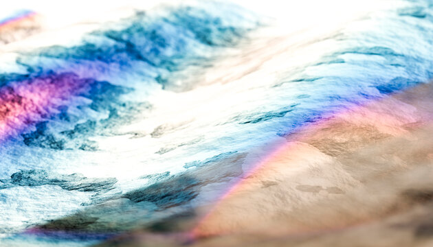 Close-up view of colorful light reflections on a water surface