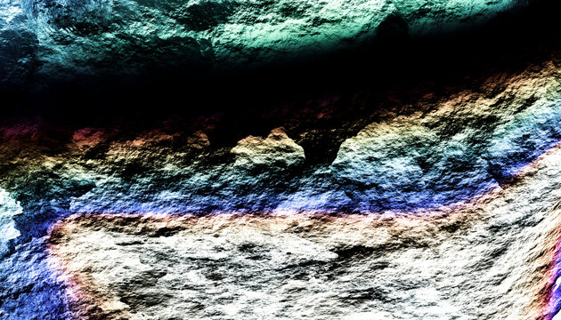 Close-up view of a textured rock surface with colorful mineral hues