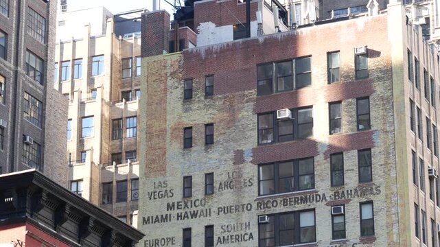 New York City Midtown urban residential building, red brown brick architecture, Manhattan rooftop, United States of America. Water tower on roof. Classic water tanks. Hells Kitchen Port Authority area