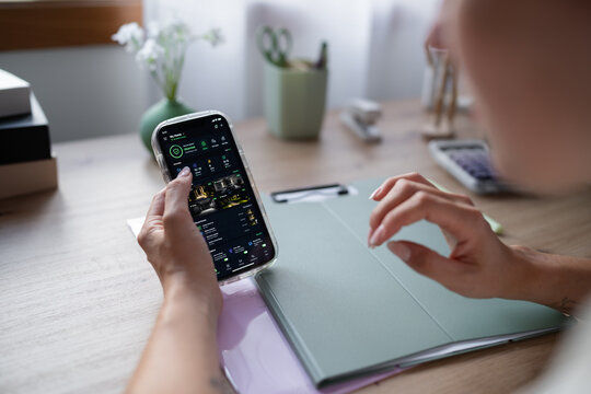 White Person using a home security application on smartphone