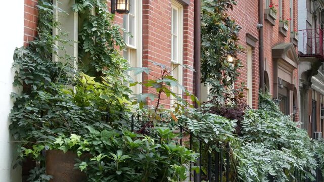 New York City urban residential buildings architecture, Manhattan classic street, Greenwich village, United States of America. Typical red brick house in NYC, real estate property in USA. West village