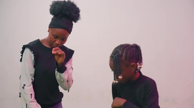 Parent guiding youngster through rhythm. Gentle tutorial of beat and timing teaching. Mother and child engaged in focused exercise on rhythm and coordination in serene studio environment