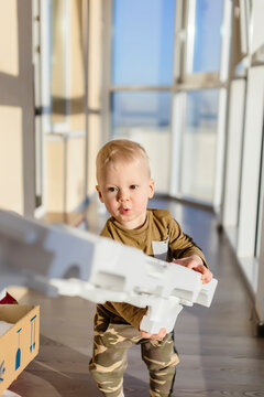 Toddler unpacking cardboard box