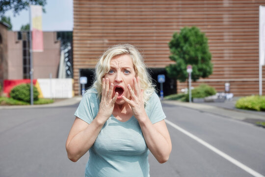 Portrait of shocked woman outdoors