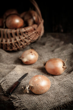 Onions and knife, basket with onions