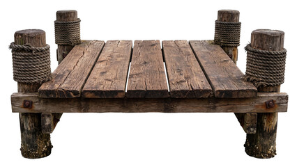 Fototapeta premium Old wooden pier platform with four timber posts wrapped in rope, weathered planks, support beams and metal fittings isolated on white background Png
